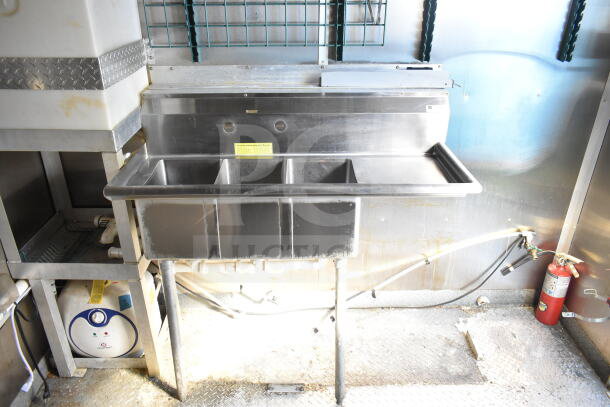 2021 Diamond Cargo 8.5'x24' food trailer interior, featuring a stainless steel triple sink and under-sink storage.