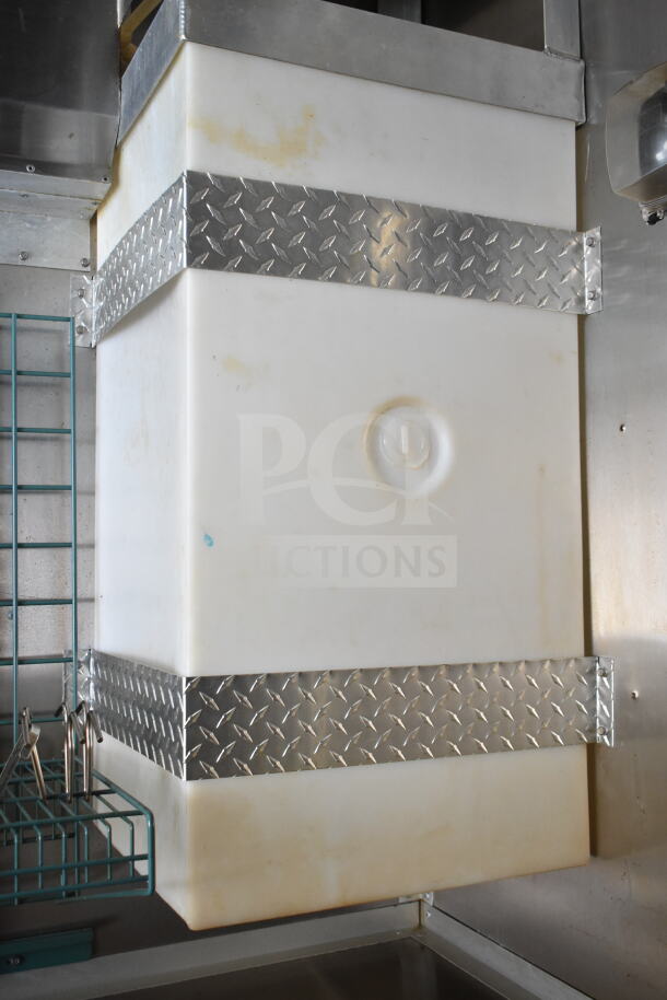 Diamond Cargo food trailer interior showing white grease hood with metal reinforcement bands. In good condition.