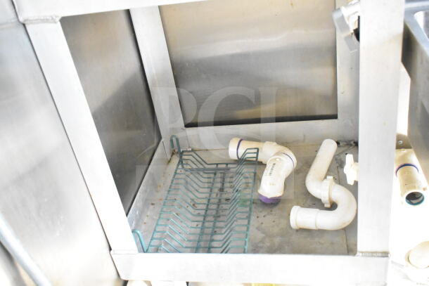 Interior of a 2021 Diamond Cargo food trailer showing plumbing and metal rack. Clean condition.
