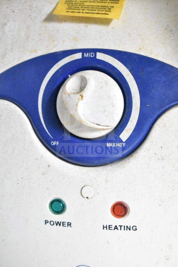 Control panel showing temperature dial and power indications. Panel is slightly worn with labels for power and heating functions.