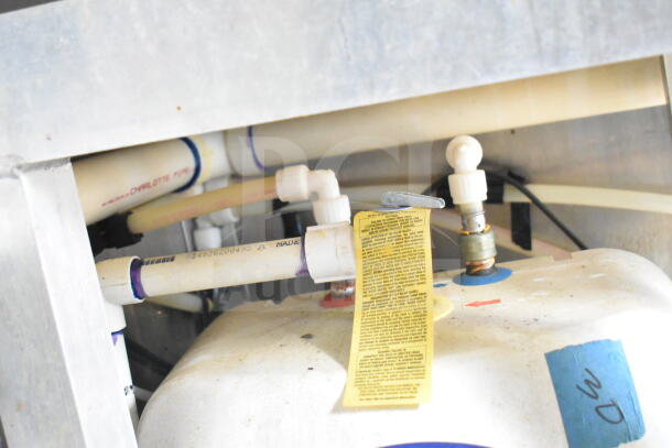 2021 Diamond Cargo food trailer plumbing, featuring PVC pipes and fittings. Yellow instruction tag visible on a pipe.