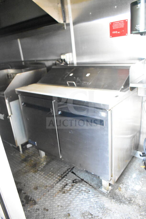 2021 Diamond Cargo 8.5'x24' food trailer interior, features stainless steel refrigeration unit, grease hood, and suppression system.
