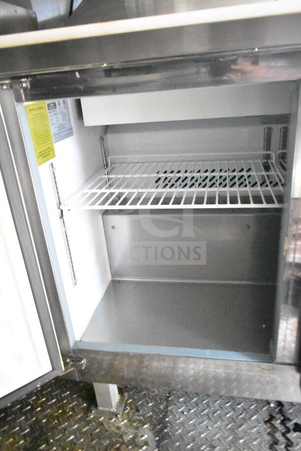 2021 Diamond Cargo 8.5'x24' food trailer interior with refrigeration unit, visible shelving, and inspection tags.