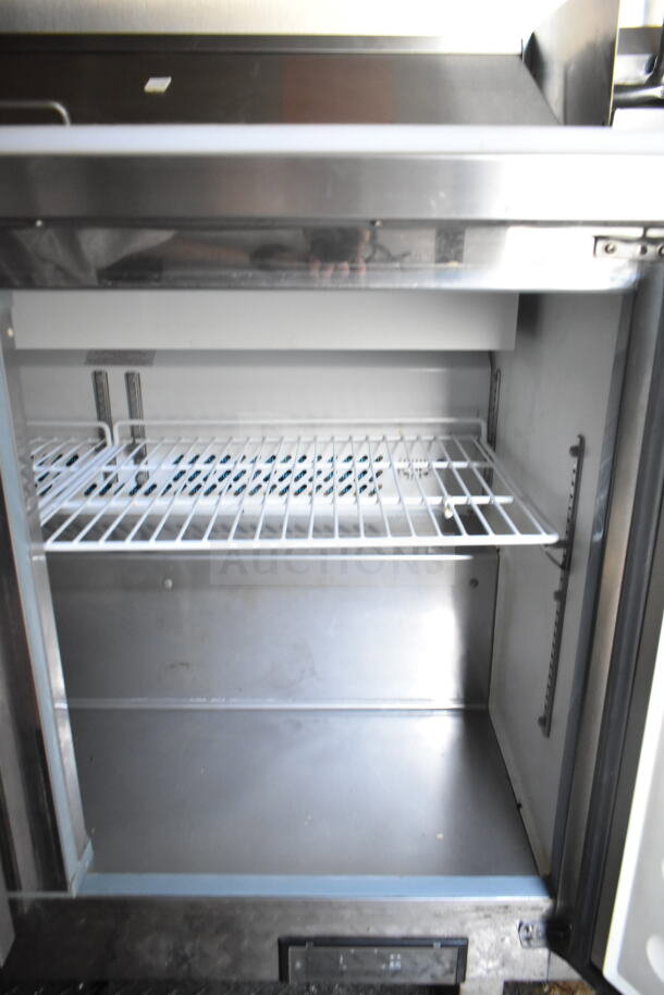 2021 Diamond Cargo food trailer interior, featuring shelving and refrigeration unit. Clean and well-maintained condition.