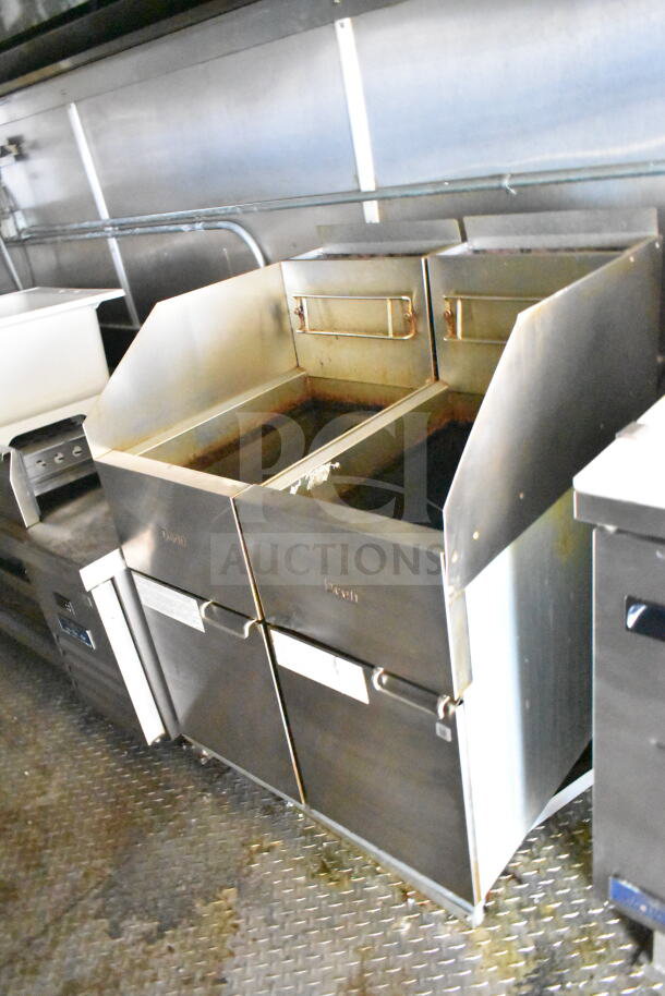 2021 Diamond Cargo 8.5'x24' food trailer interior showing Frymaster gas fryer under grease hood. Clean, functional condition.