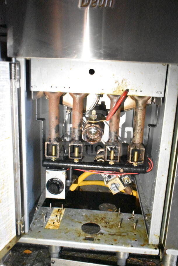 Interior view of Frymaster gas fryer in 2021 Diamond Cargo food trailer, showing heating elements and piping. Used condition.