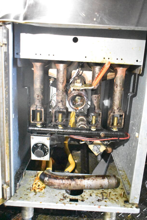 Interior view of Frymaster gas fryer components in Diamond Cargo 8.5'x24' food trailer, showing used condition with visible grease build-up.