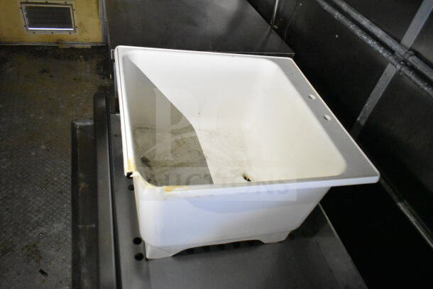 White sink inside 2021 Diamond Cargo 8.5'x24' Food Trailer, showing wear and dirt. Part of kitchen setup.