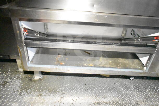 2021 Diamond Cargo 8.5'x24' food trailer interior showing storage compartment. Features stainless steel construction.