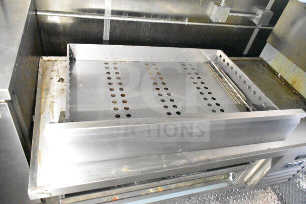 2021 Diamond Cargo 8.5'x24' food trailer interior, featuring a grease hood and Frymaster gas fryer, clean condition.