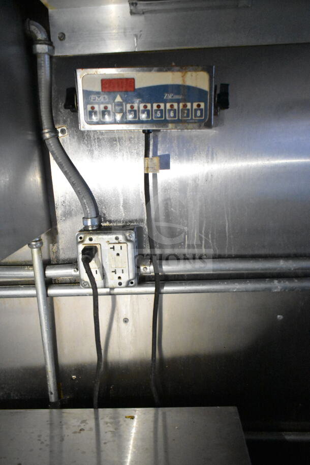 Electrical panel inside 2021 Diamond Cargo food trailer with grease hood. Visible wiring and GFCI outlets. Stainless steel interior.