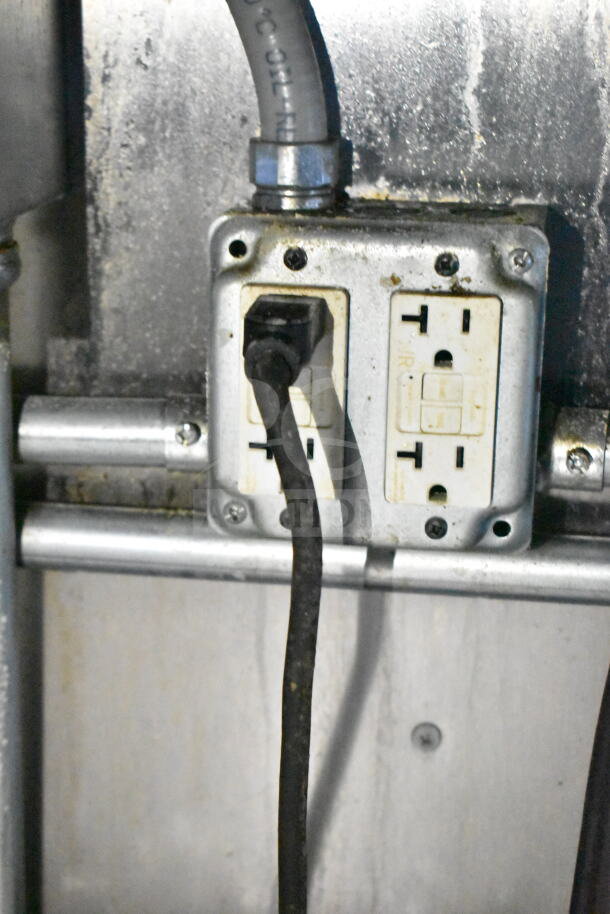 Electrical outlet with dual sockets in used condition, part of the 2021 Diamond Cargo food trailer's interior wiring system.