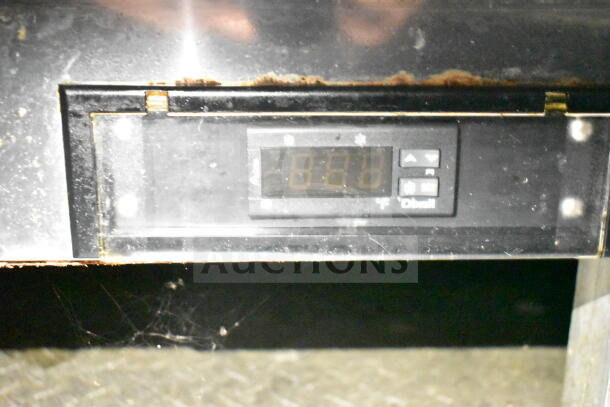Close-up of a control panel in a 2021 Diamond Cargo food trailer, showing temperature settings and buttons.