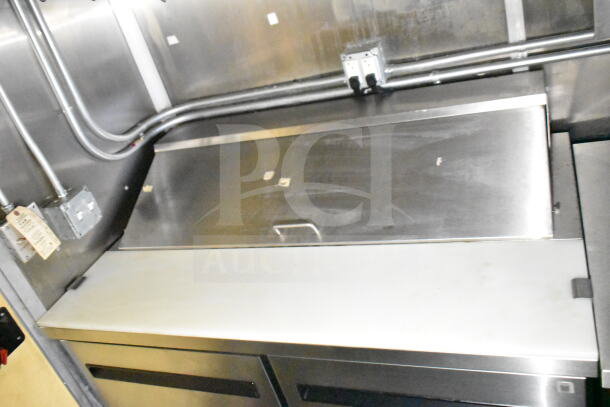 2021 Diamond Cargo 8.5'x24' food trailer interior with stainless steel countertop, grease hood, and electrical outlets.