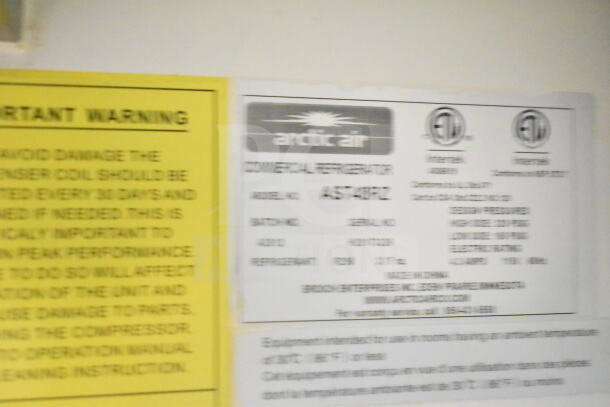 Arctic Air AST48RZ commercial refrigerator label, features model and serial numbers, operational specs, and maintenance warnings.