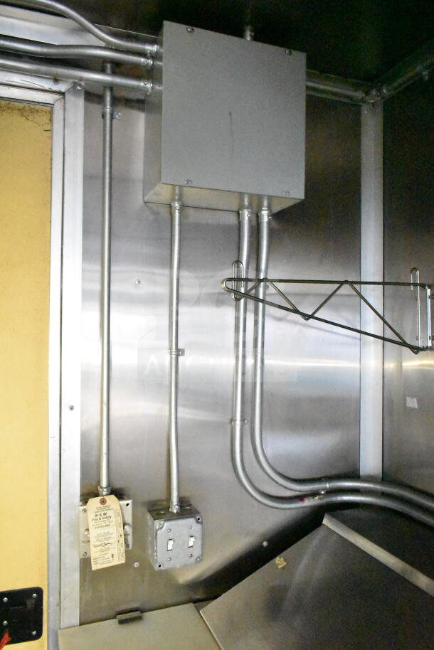 2021 Diamond Cargo 8.5'x24' food trailer interior wiring, showing metal conduits, junction box, and wall outlet with safety tag.