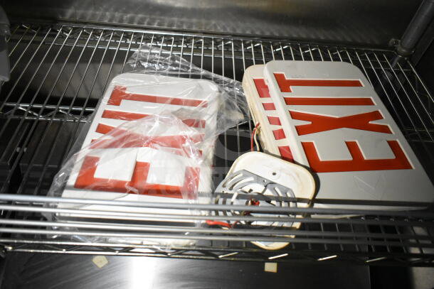 Shelves inside the 2021 Diamond Cargo food trailer holding exit signs and light fixtures, indicating ready-to-use condition.