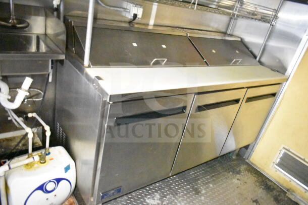 2021 Diamond Cargo 8.5'x24' food trailer interior with refrigeration unit, prep counters, visible piping, and storage space.