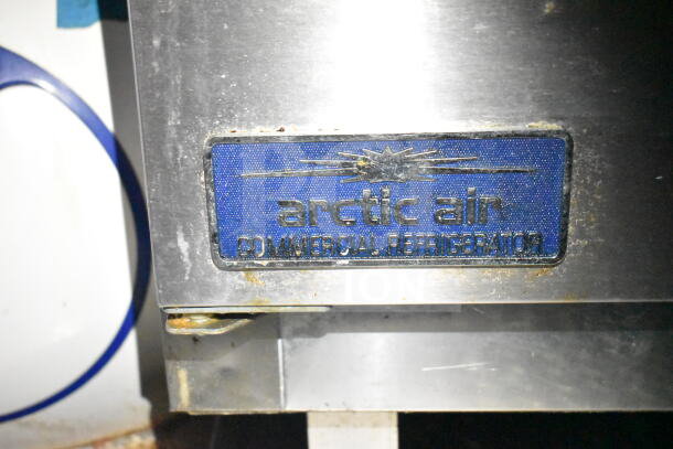 "Arctic Air Commercial Refrigerator label on stainless steel, part of 2021 Diamond Cargo 8.5'x24' food trailer features."