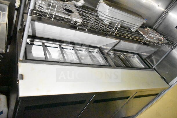 2021 Diamond Cargo 8.5'x24' food trailer interior, featuring stainless steel prep station and shelving, clean condition.