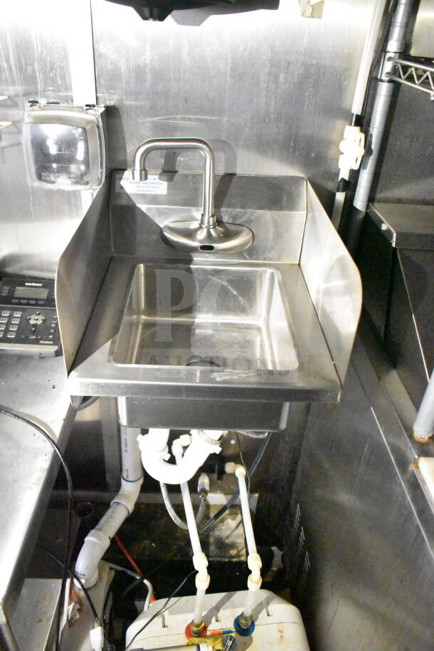 Stainless steel sink with faucet in a 2021 Diamond Cargo 8.5'x24' food trailer. Visible piping and soap dispenser mounted.