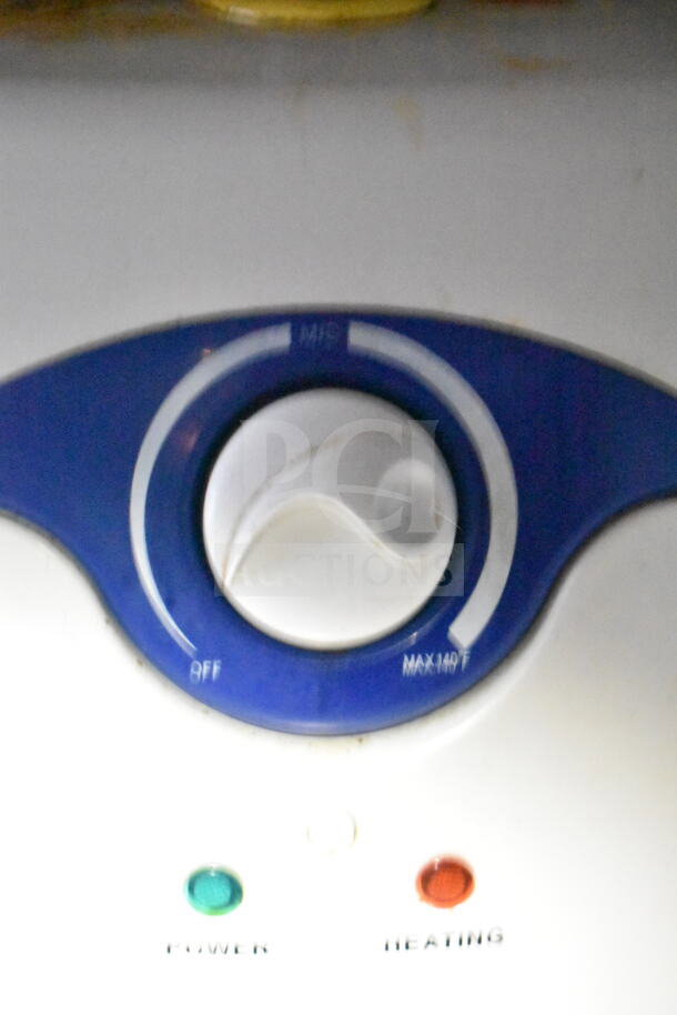Alt text: Close-up of a temperature control dial with power and heating indicators.