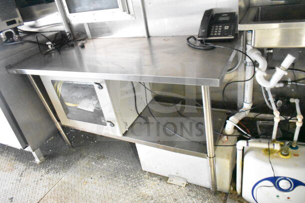 2021 Diamond Cargo 8.5'x24' food trailer interior, features stainless steel prep table, wiring, and plumbing.