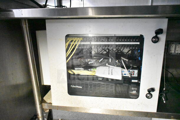 Food trailer interior showing a network video recorder setup with cables and CyberPower unit, part of 2021 Diamond Cargo 8.5'x24' model.