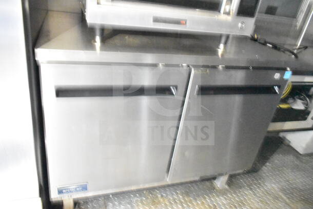 8.5'x24' Diamond Cargo food trailer interior, featuring stainless steel refrigeration unit, grease hood, and gas fryer.