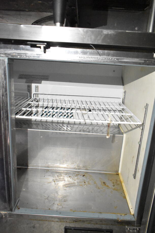Interior of 2021 Diamond Cargo food trailer's refrigeration unit showing metal shelf and interior lining.