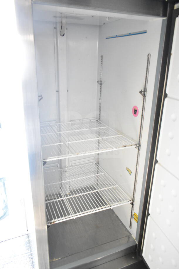 Interior view of 2021 Diamond Cargo 8.5'x24' food trailer showing storage shelves and clean, spacious refrigeration unit.