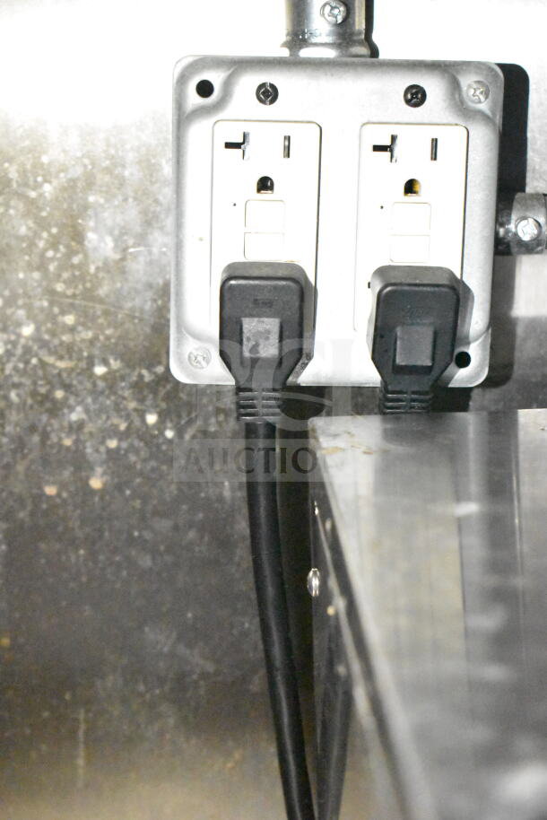 Electrical outlet inside 2021 Diamond Cargo food trailer, featuring dual plug sockets for appliance connectivity.