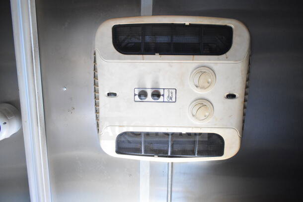2021 Diamond Cargo food trailer interior with overhead grease hood and air vents, visible wear, clean metal surroundings.