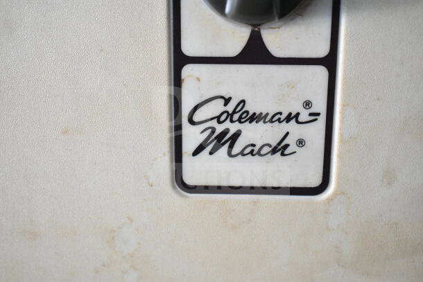 Coleman-Mach logo on a textured surface, indicating the brand of an appliance, possibly from the 2021 Diamond Cargo food trailer.