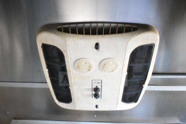 Interior view of grease hood in 2021 Diamond Cargo 8.5'x24' food trailer, showing controls and vents.