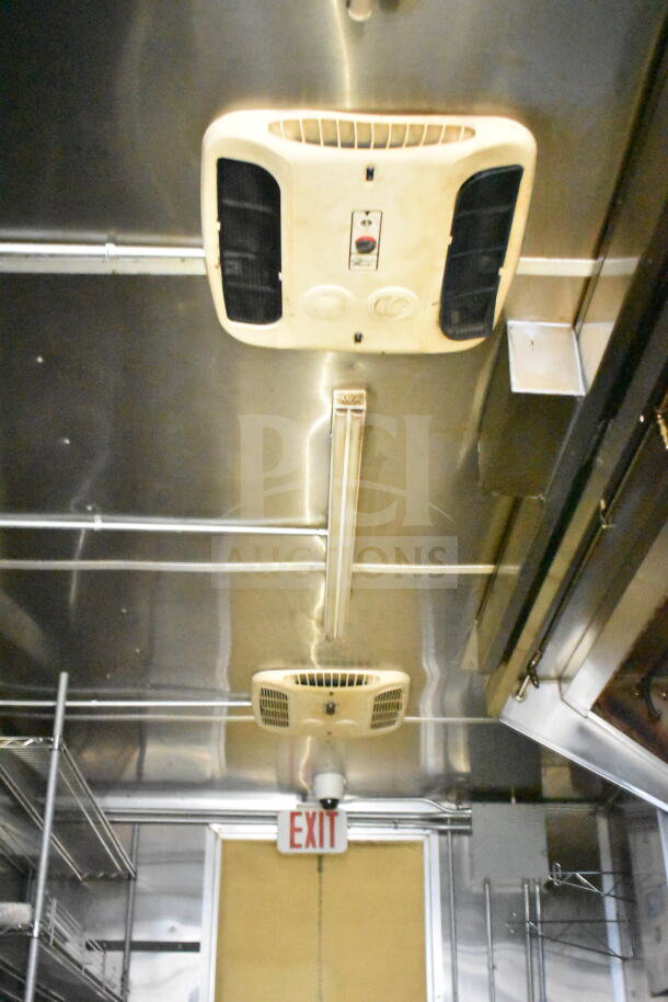 2021 Diamond Cargo 8.5'x24' food trailer interior with grease hood, suppression system, and shelving. Clean and well-equipped.