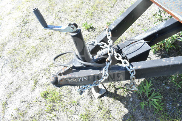 Trailer hitch of 2021 Diamond Cargo 8.5'x24' food trailer with chain and visible markings "89713" on frame.