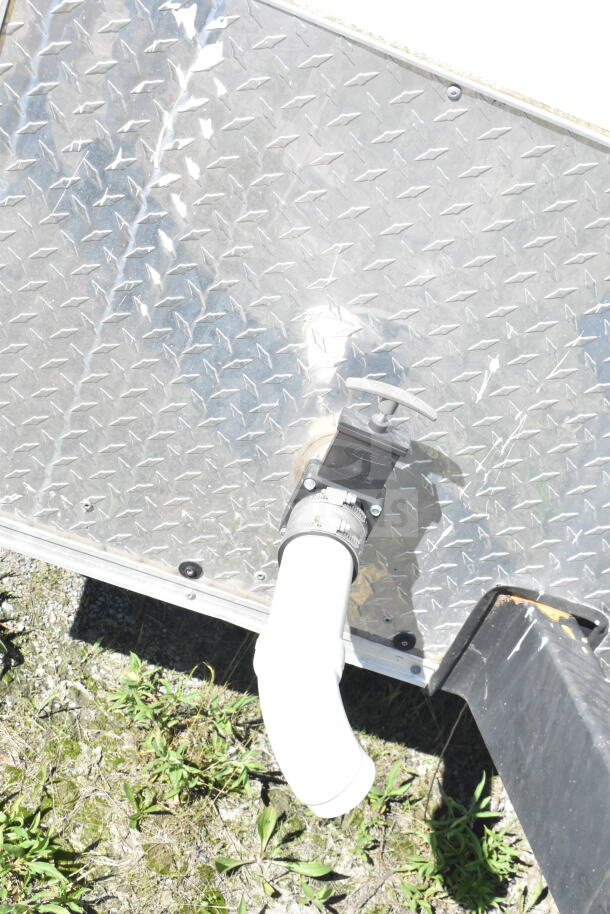 Diamond plate exterior of a 2021 Diamond Cargo 8.5'x24' food trailer. Features visible piping connection.