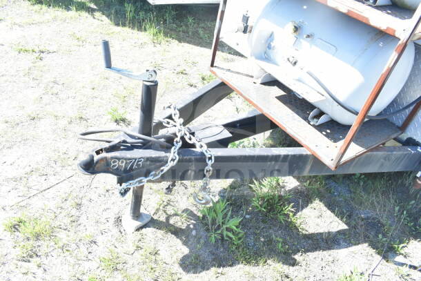 2021 Diamond Cargo 8.5'x24' food trailer hitch with chain and propane tank. Marking "89713" visible on hitch.