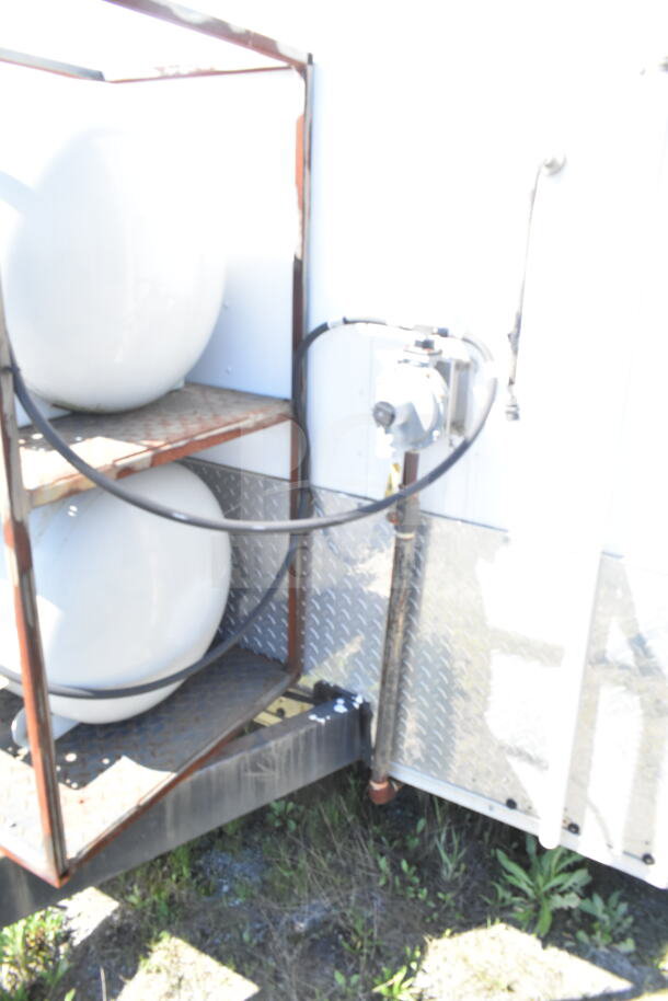 2021 Diamond Cargo 8.5'x24' food trailer exterior with propane tank storage, hoses visible.