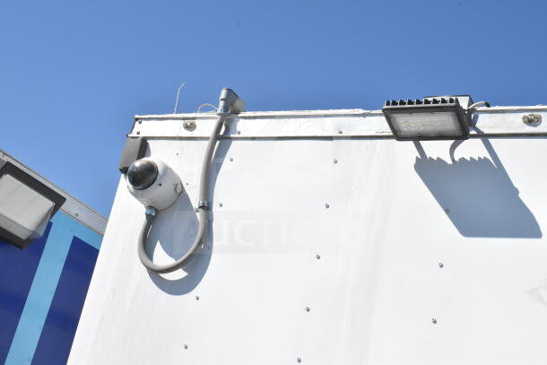 2021 Diamond Cargo 8.5'x24' food trailer with visible security camera. Includes grease hood, suppression system, refrigeration, Frymaster gas fryer. VIN: 53NBE242XM1089713.
