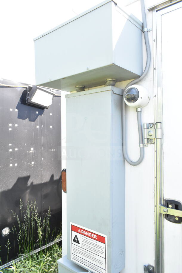 2021 Diamond Cargo 8.5'x24' food trailer, white exterior, electrical panel with danger label, security camera visible.