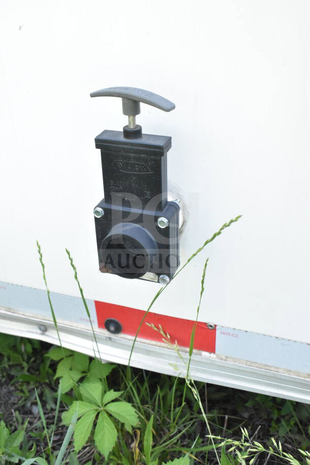 Close-up of a valve on a 2021 Diamond Cargo 8.5'x24' food trailer, featuring a grease hood and suppression system.
