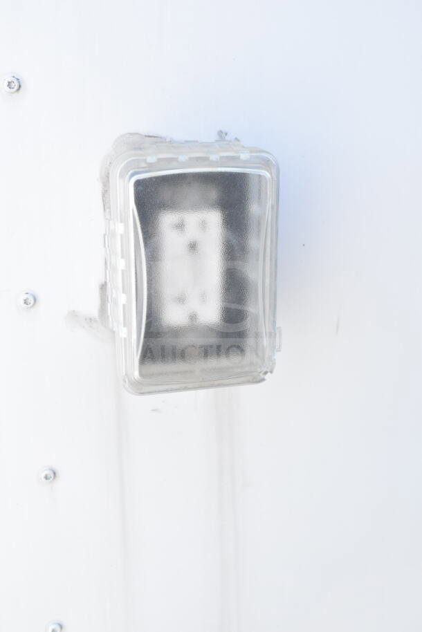 Exterior view of 2021 Diamond Cargo food trailer, showing a protective cover on an outlet. VIN: 53NBE242XM1089713.