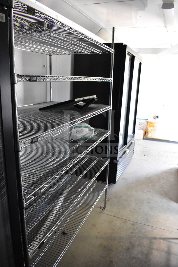 2021 Diamond Cargo 8.5'x24' food trailer interior with metal shelving.