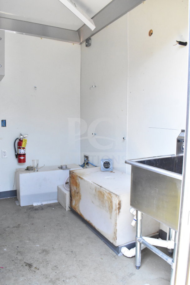 2021 Diamond Cargo 8.5'x24' food trailer interior, featuring a stainless steel sink and worn utility area.