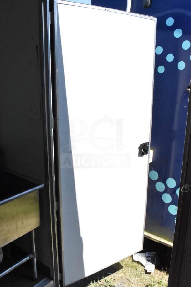 2021 Diamond Cargo 8.5'x24' food trailer, model VIN 53NBE2424M1089867, partial view with open door.