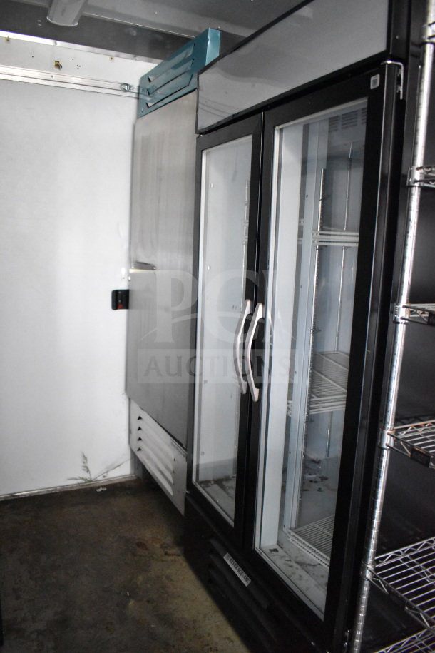2021 Diamond Cargo 8.5'x24' food trailer interior showing commercial refrigerator and metal shelving, in good condition.