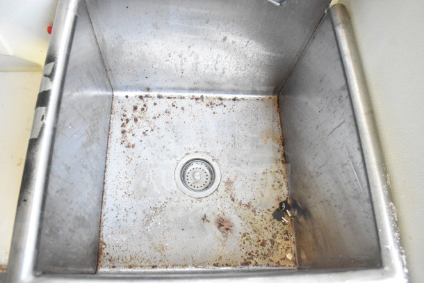 Stainless steel sink in Diamond Cargo food trailer, showing signs of wear and rust.