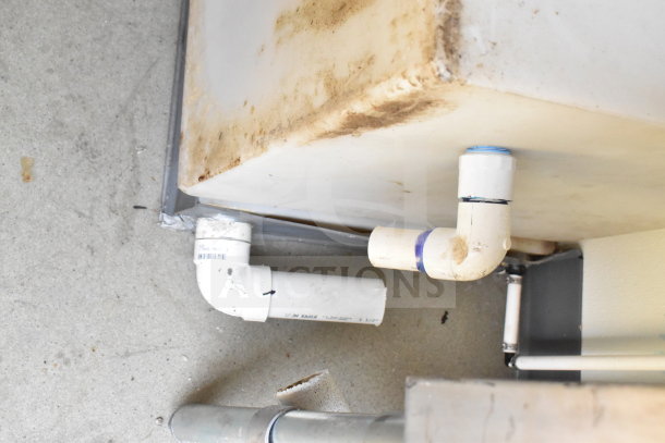 2021 Diamond Cargo 8.5'x24' Food Trailer plumbing detail. Condition shows wear with visible dirt on pipes and tank.